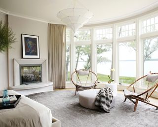 neutral main bedroom with sitting area, gray rug and white light