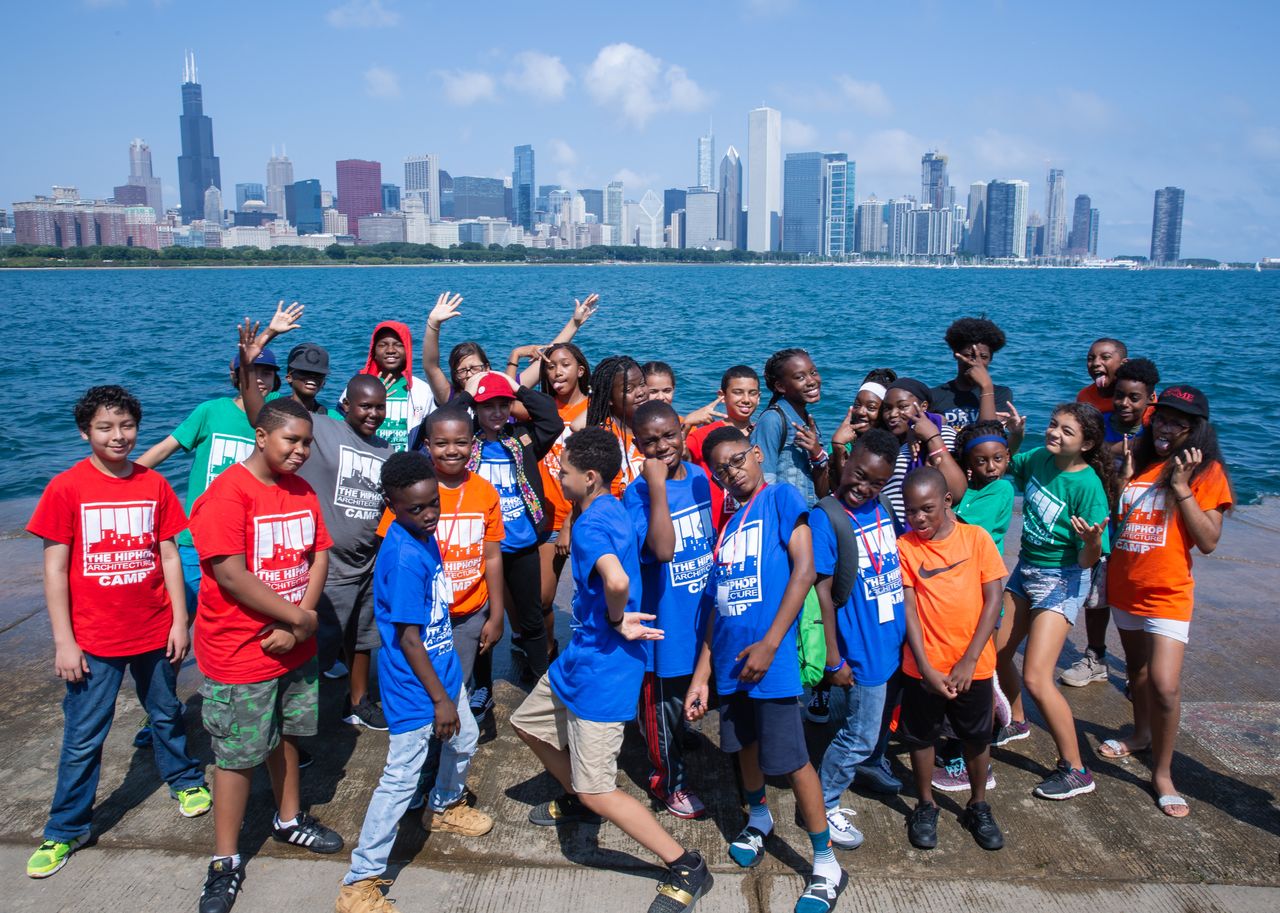 A group of kids with colourful t-shirts with Chicago in the background