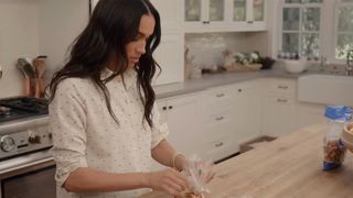 Meghan puts pretzels into a smaller plastic bag in now-viral With Love, Meghan moment.