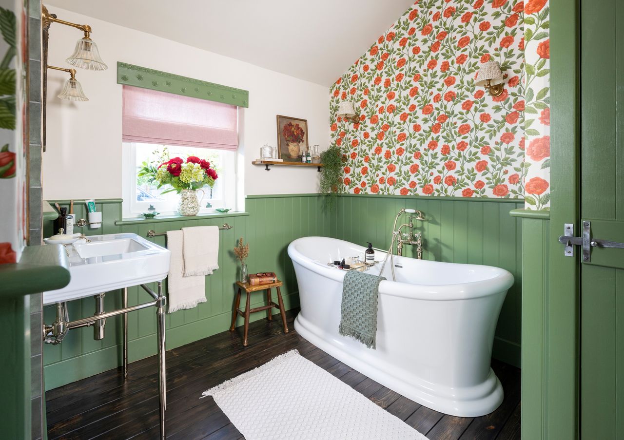 A green Victorian style bathroom with rose wallpaper