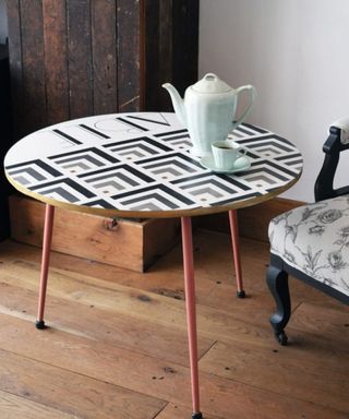 A DIY upcycled coffee table with art deco style paint decor in white grey and black