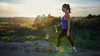 Woman going for a walking workout in nature wearing activewear