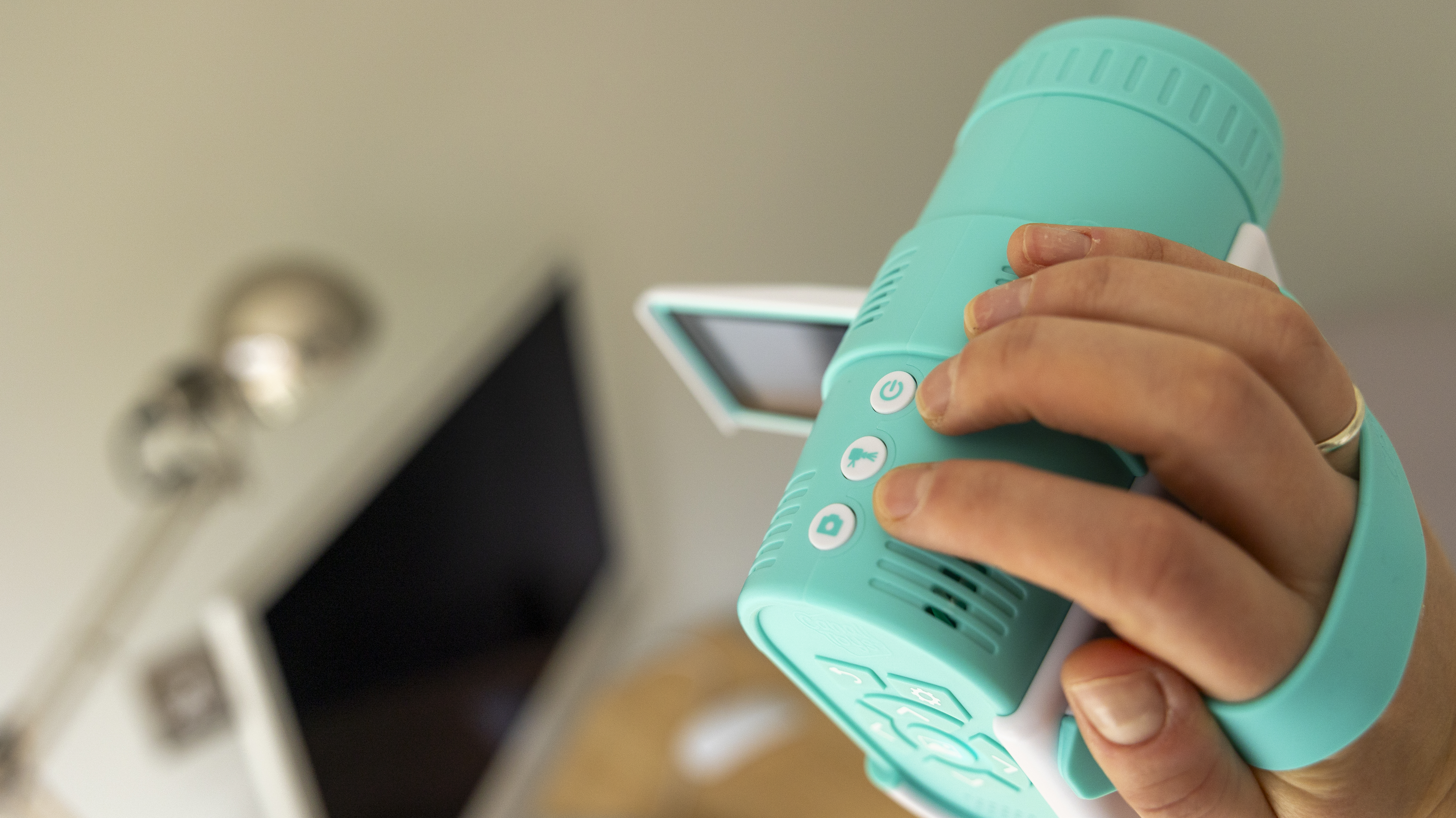 The Photo Creator projector video camera being handled in a home office