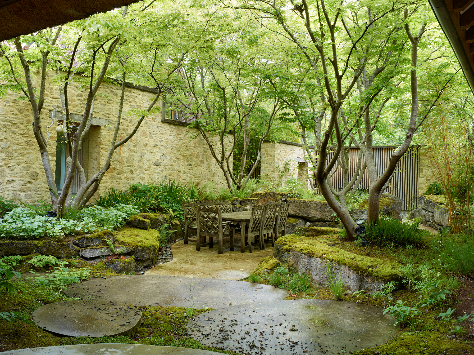 green garden with trees and patios