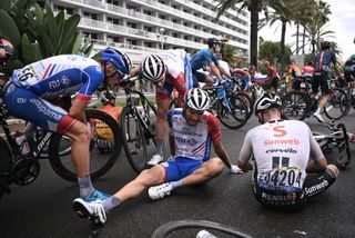 Team Groupama-FDJ rider Frances Thibaut Pinot lies on the ground after a crash during the 1st stage of the 107th edition of the Tour de France