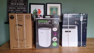 Three dehumidifiers in boxes on table