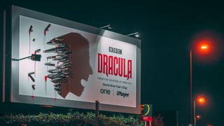 Billboard advertising showing a Dracula poster made from the shadow of various stakes