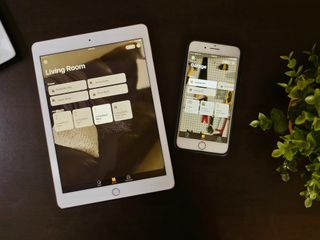 iPad and iPhone sitting on a table with the Home app displayed