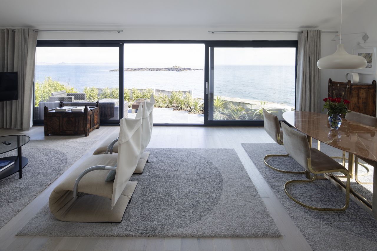 living room with view to sea through sliding doors