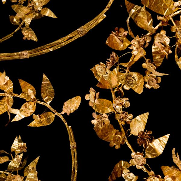 A gold leaf composition features floral motifs.