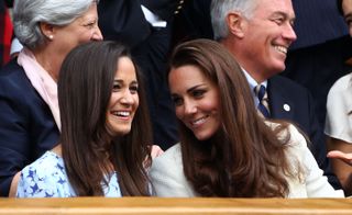 Pippa Middleton (L) and Catherine, Duchess of Cambridge sit in the Royal Box during the Gentlemen's Singles final match between Roger Federer of Switzerland and Andy Murray