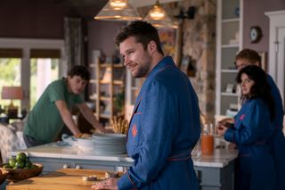 Sam Nivola as Will Winbury, Jack Reynor as Thomas Winbury, Eve Hewson as Amelia Sacks, Billy Howle as Benji Winbury in episode 101 of The Perfect Couple.