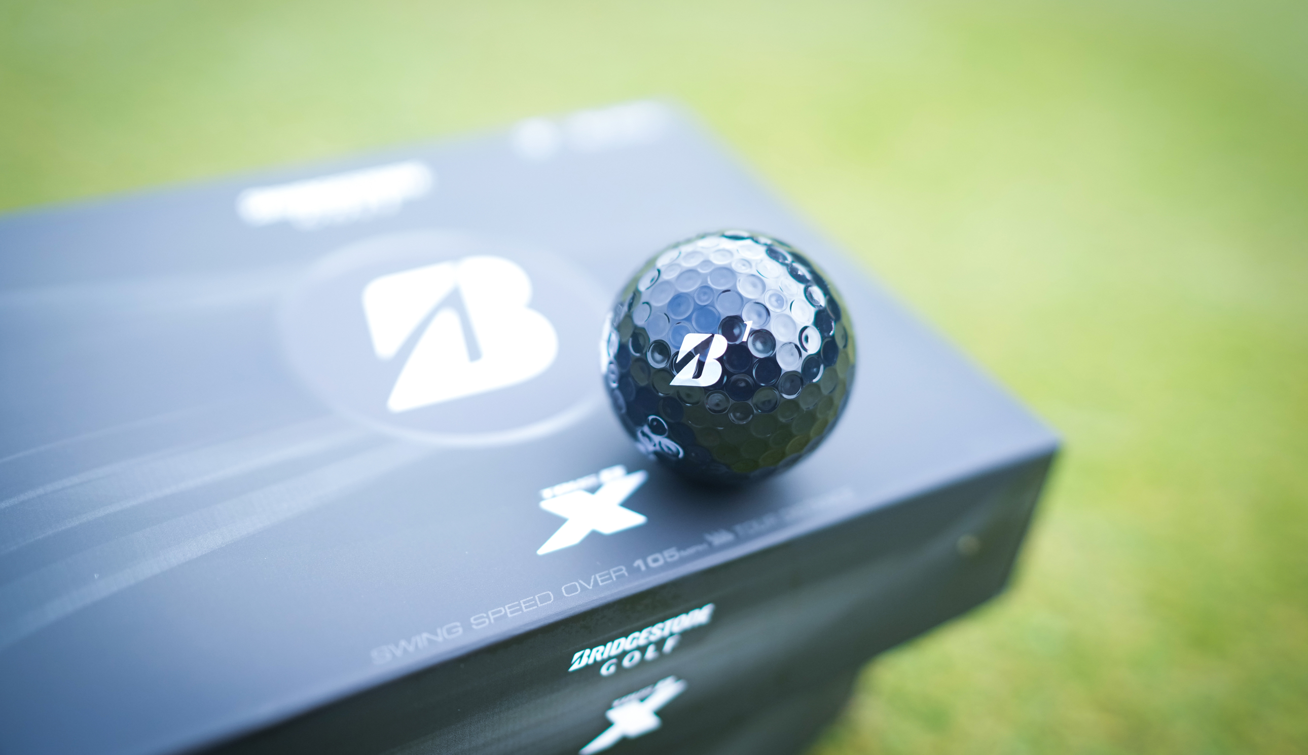 The Bridgestone Tour B X Golf Ball on a box