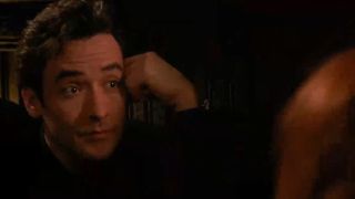 A close up of John Cusack looking bemused in Grosse Pointe Blank