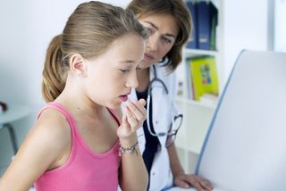 Girl coughing at the doctor's office