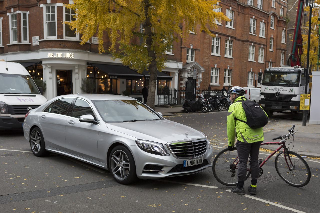 A cyclist confronts a car