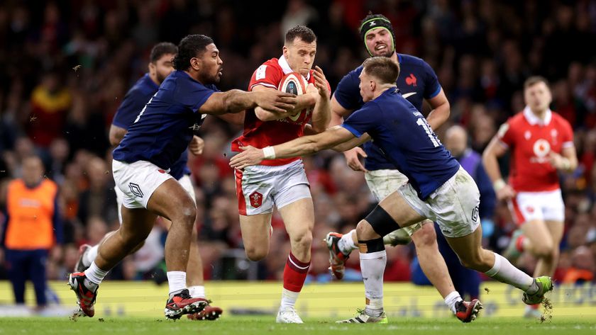 Three French players tackle a Welsh player with the ball during the France vs Wales match at the 2024 Six Nations