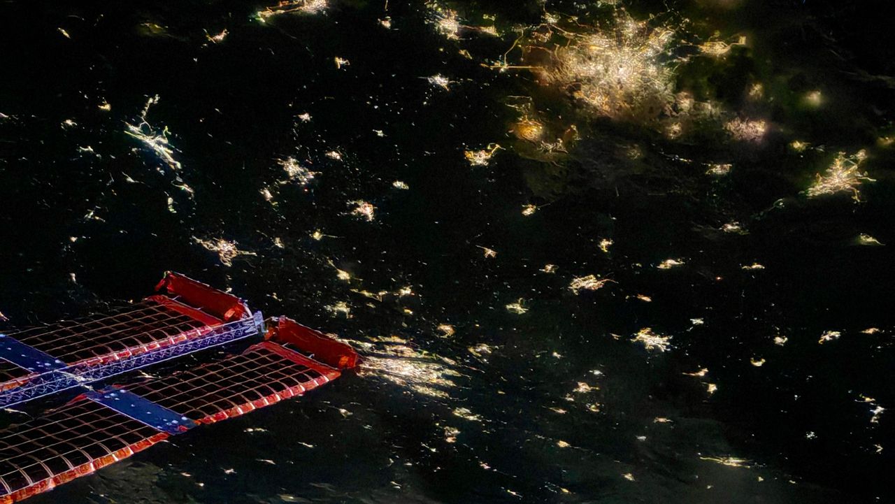 The flexibility of Tiangong's solar arrays is evident in this image showing a nighttime city down on Earth.