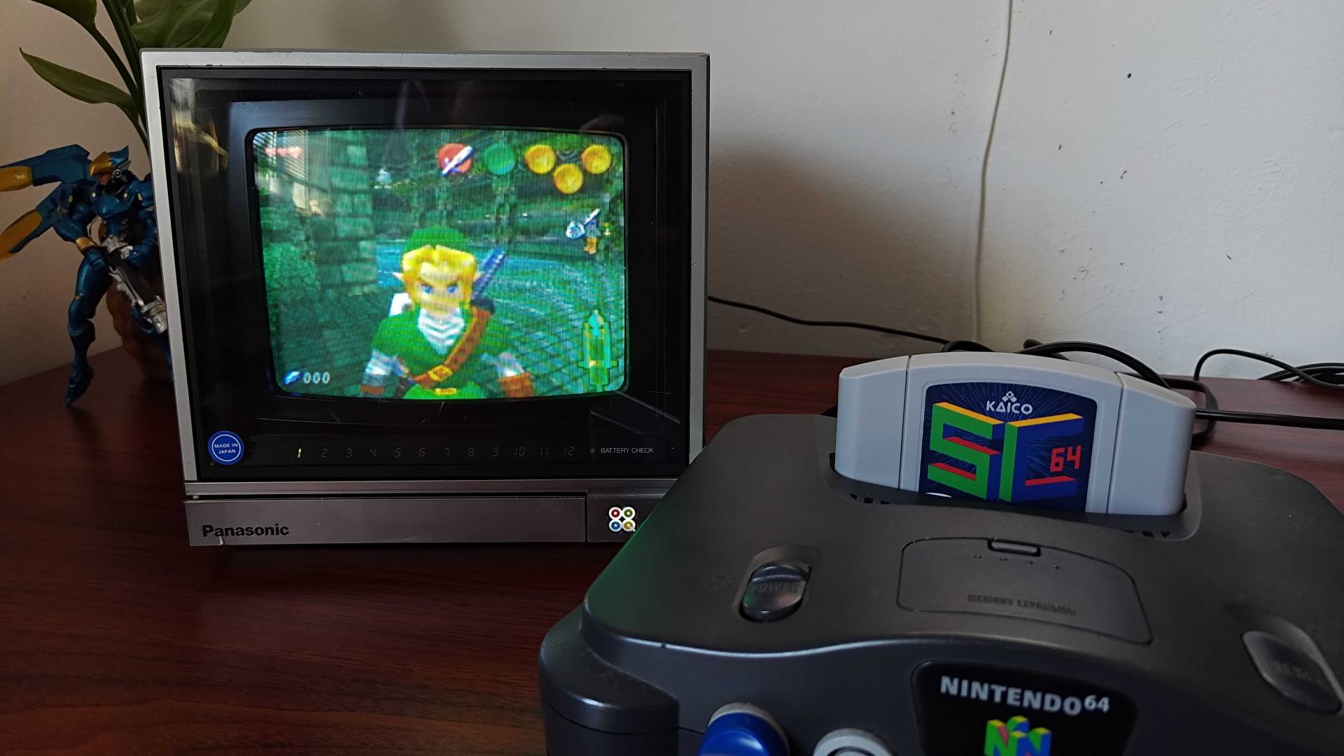 CRT and N64 sitting on woodgrain desk with SC64 cart running Zelda: Ultimate Trial ROM hack.