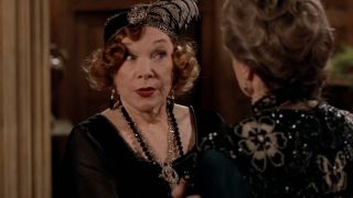 Shirley MacLaine puts her hands on Dame Maggie Smith's arms as she speaks in Downton Abbey.