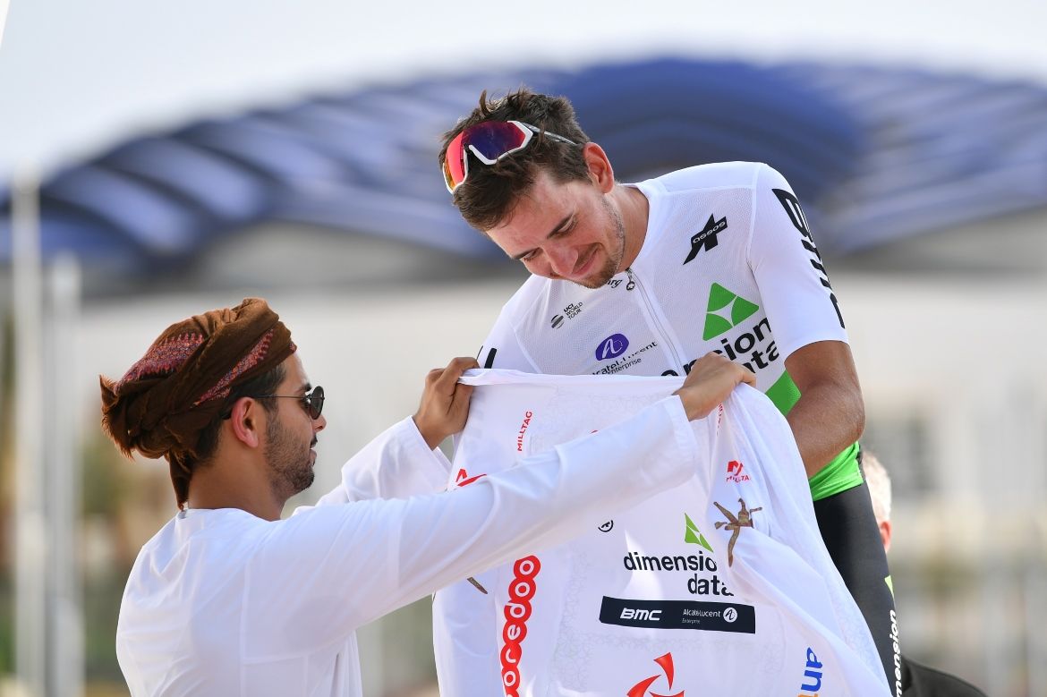Ryan Gibbons puts on the white jersey of best young rider