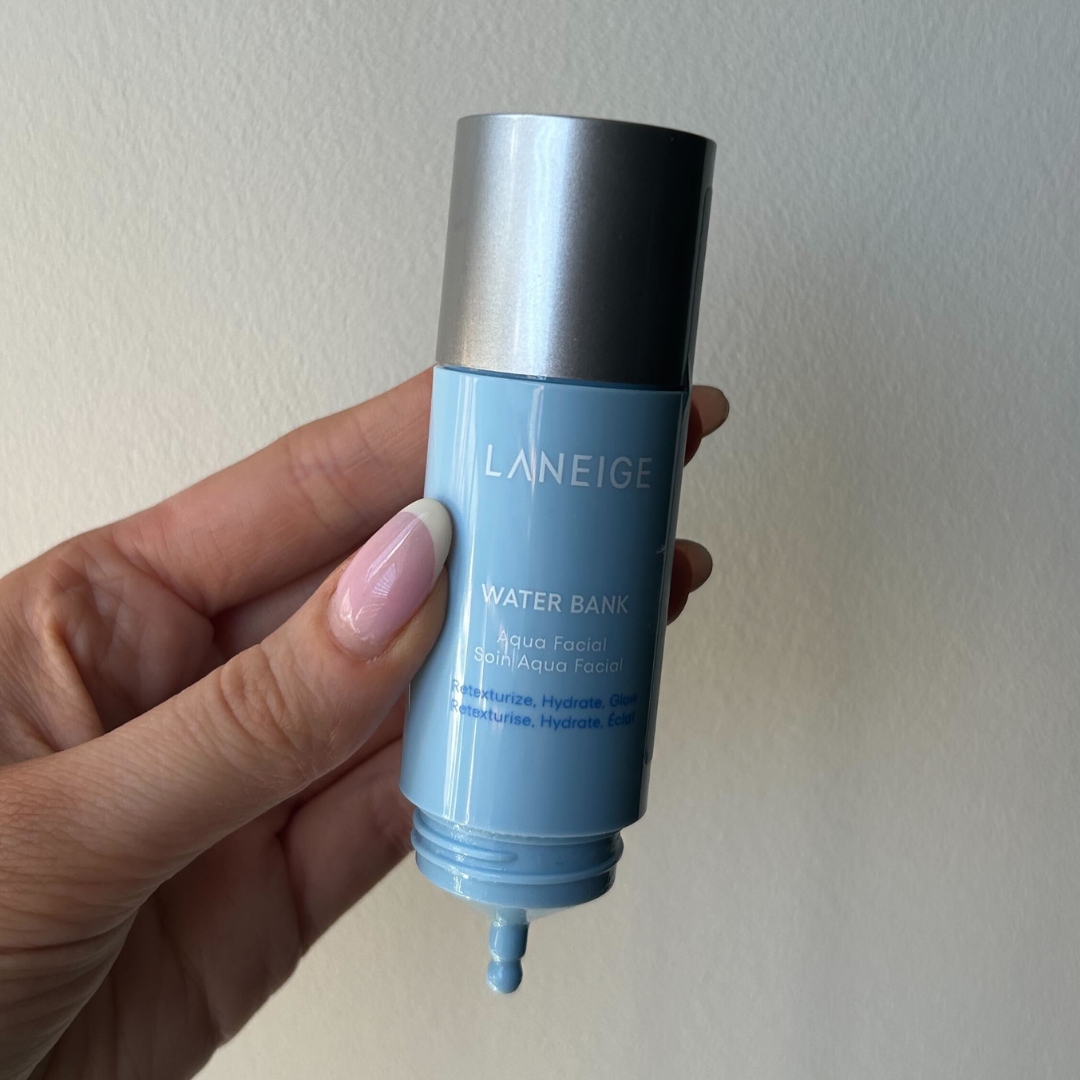 Hand holding empty bottle of LANEIGE Water Bank Aqua Facial