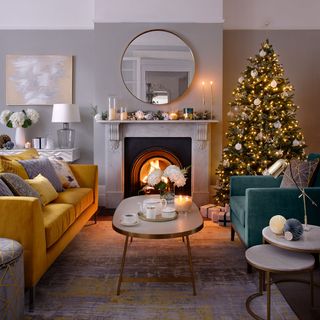 grey living room with mustard sofa and marble mantlepiece