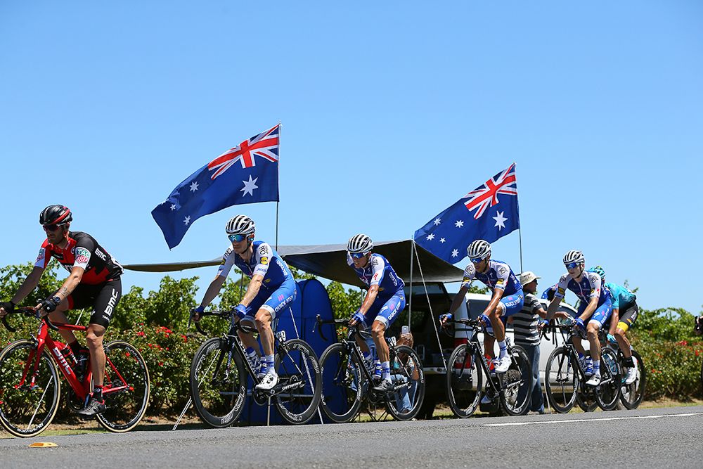 Australian flags fly as the peloton passes