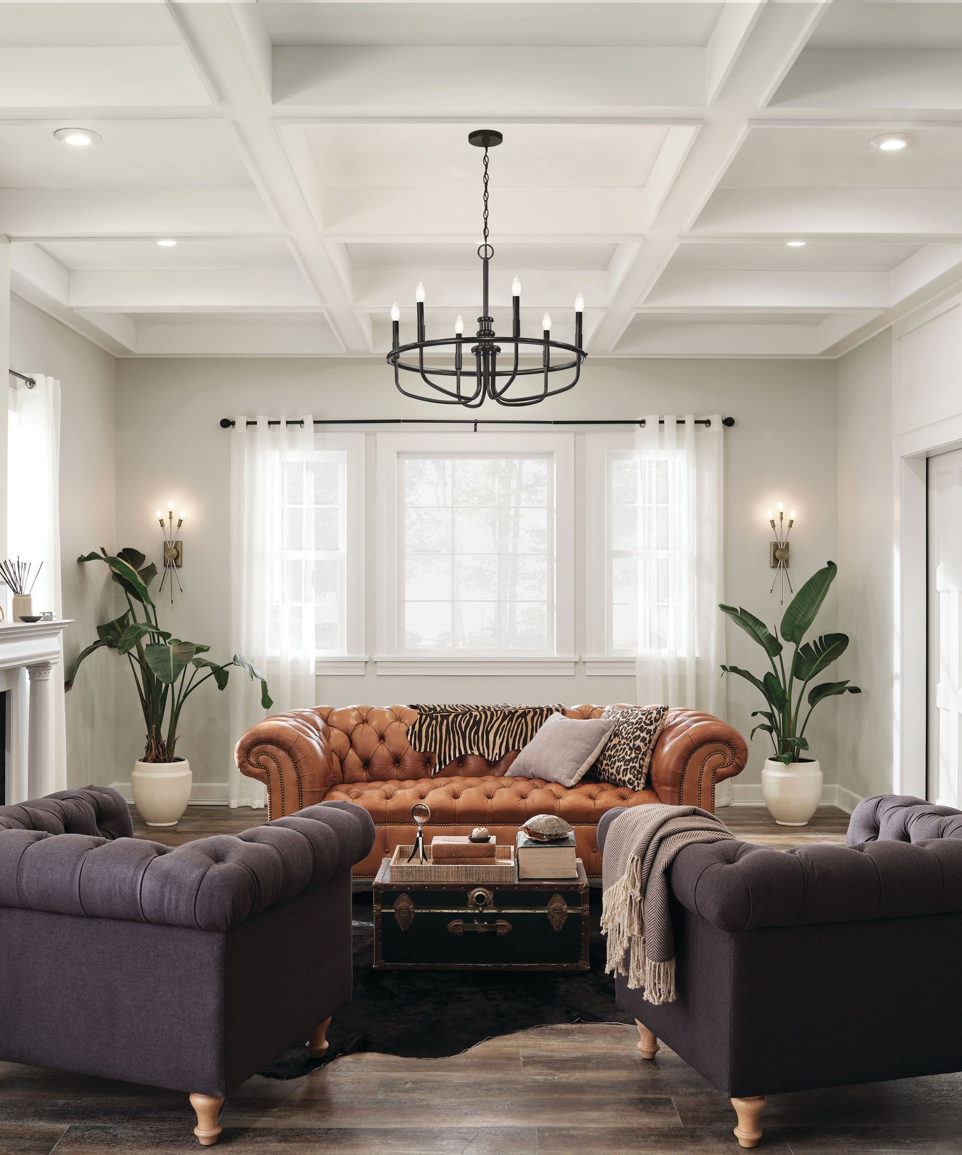 How to plan living room lighting with wall lamps by Kichler, an orange sofa and two purple armchairs