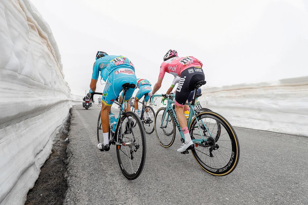 The leaders climb on snow-lined roads during stage 19 at the Giro.