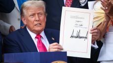 U.S. President Donald Trump, joined by Republican lawmakers, signs the One, Big Beautiful Bill Act into law during an Independence Day military family picnic on the South Lawn of the White House on July 04, 2025 in Washington, DC