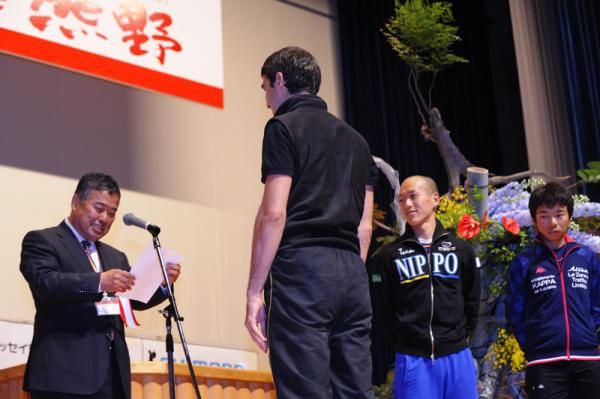 Riders receive the prizes after the prologue