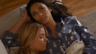 Emily and Alison laying together on a couch.
