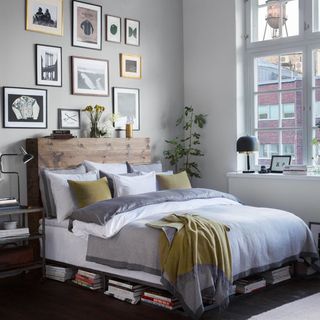 bedroom with wooden bed and grey wall