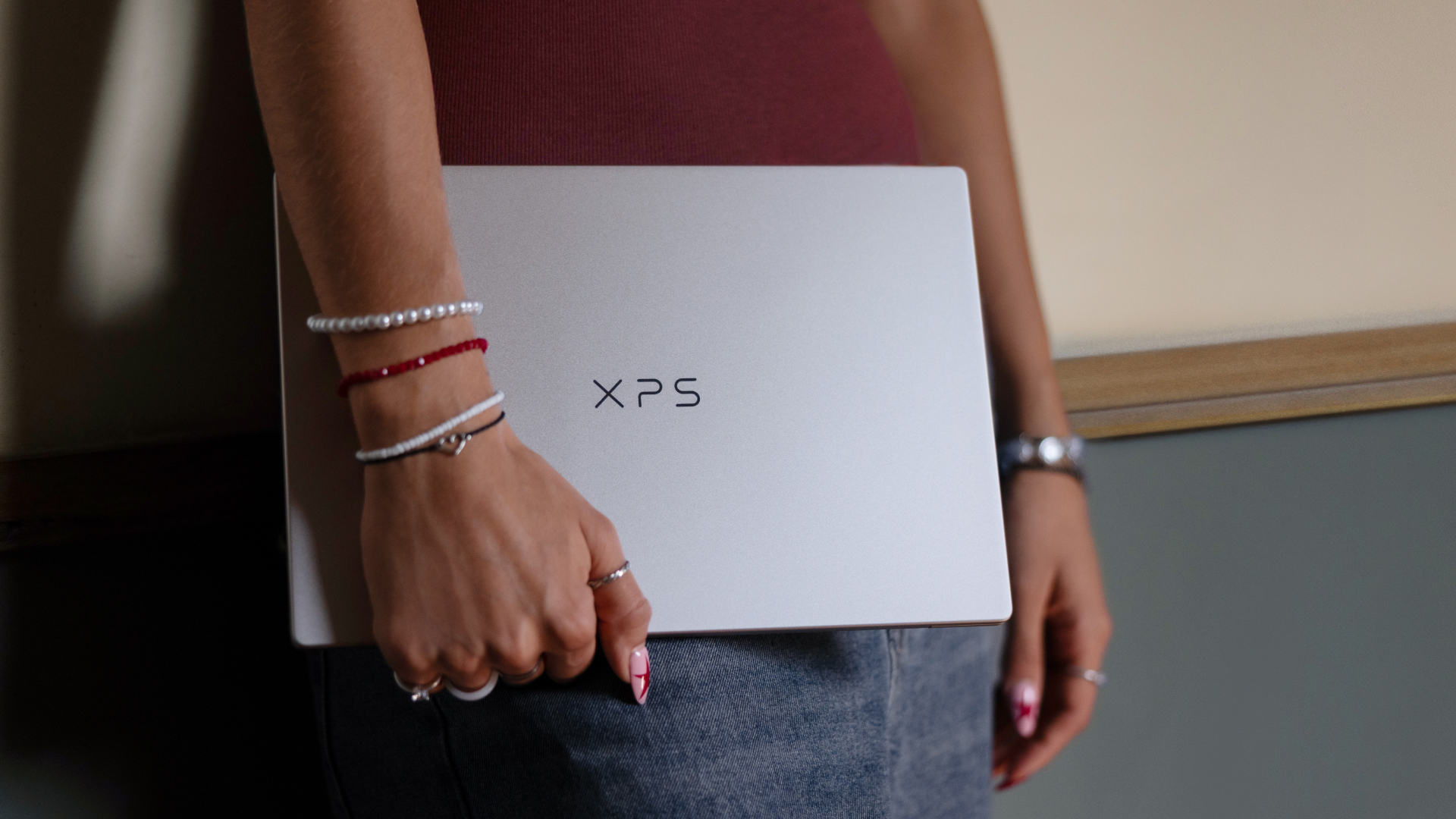 Dell XPS 13 laptop closed, being carried in someone's hand