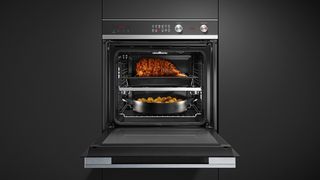 Fisher & Paykel oven with meat and roast potatoes in it