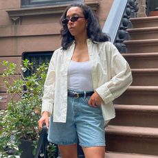 Lauren Tappan wearing a yellow button-down and denim bermuda shorts