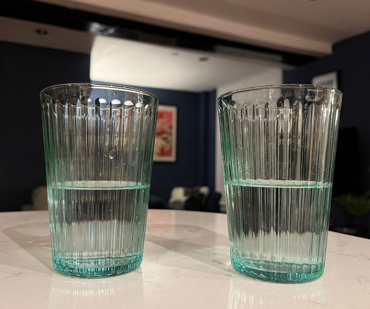 glasses of water on worktop, followed by boy smelling and tasting water