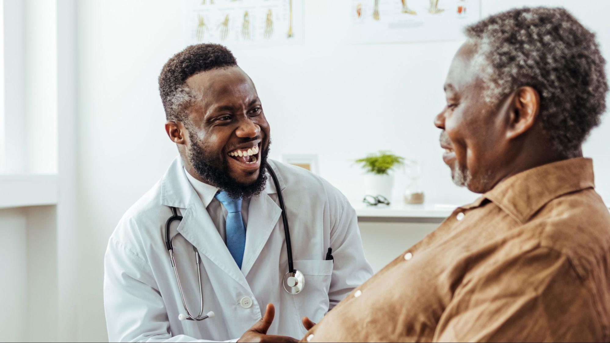 A smiling doctor speaking to their patient.