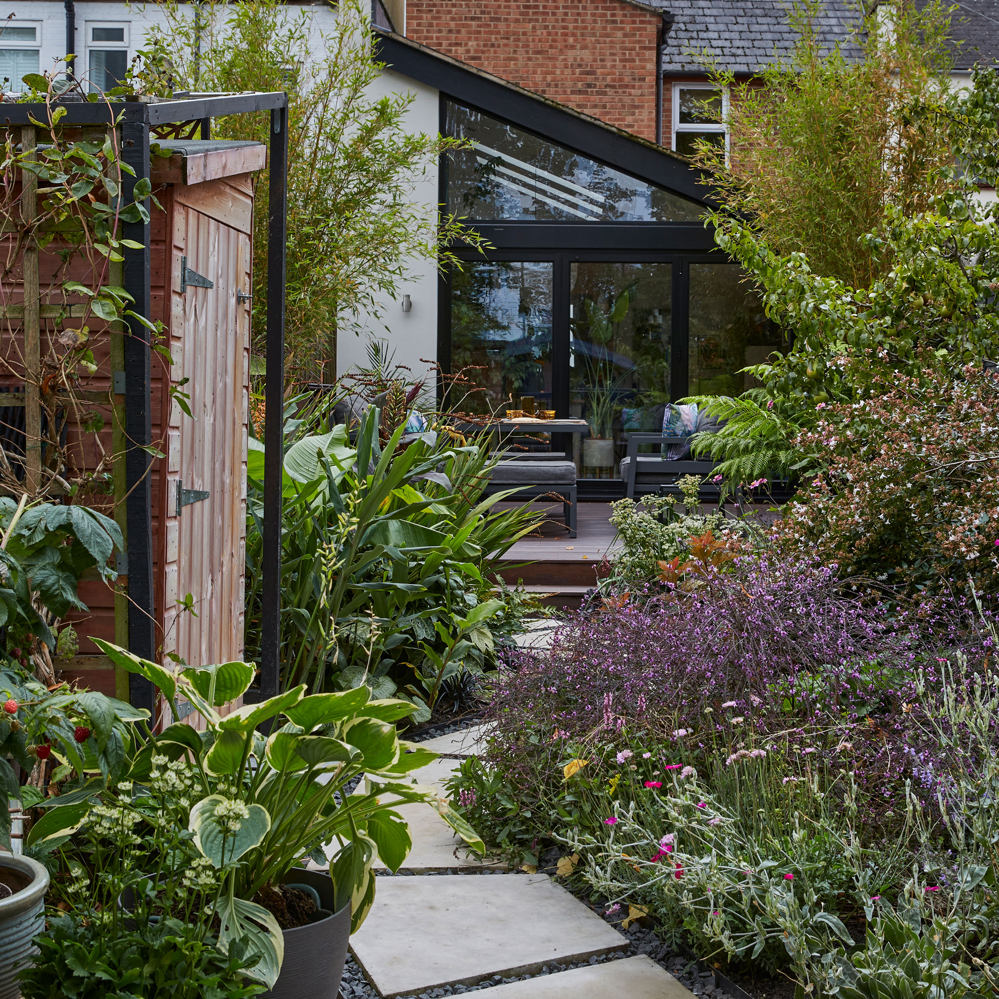 A bespoke zig-zag path leads the way into this colourful garden ...