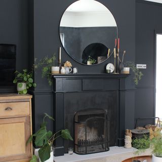 Black living room with the fireplace painted black to match