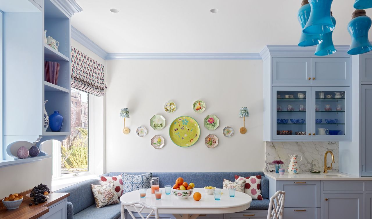 A kitchen with serving platters displayed on the wall