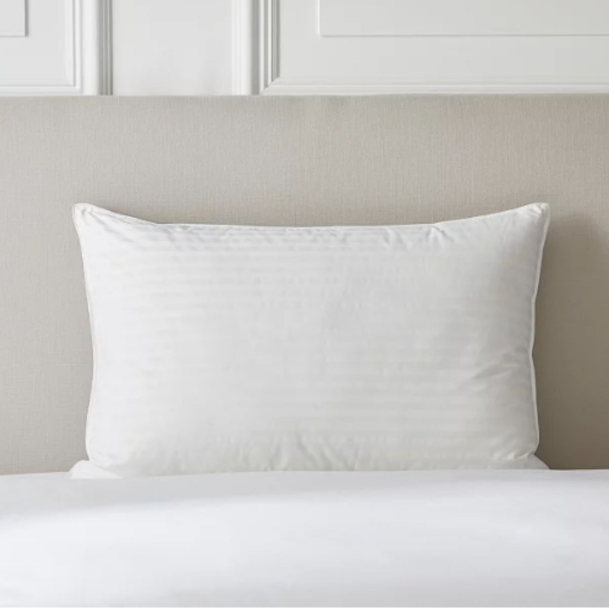 Luxury Hungarian Goose Down Pillow on white bed and cream headboard