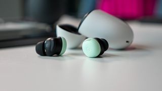 The green Google Pixel Buds Pro 2 out of their case