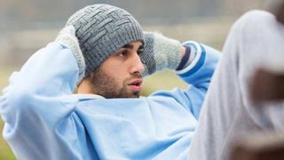 man doing sit-ups outdoors