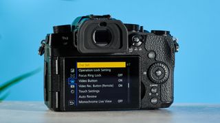 A black Panasonic Lumix G97 mirrorless camera