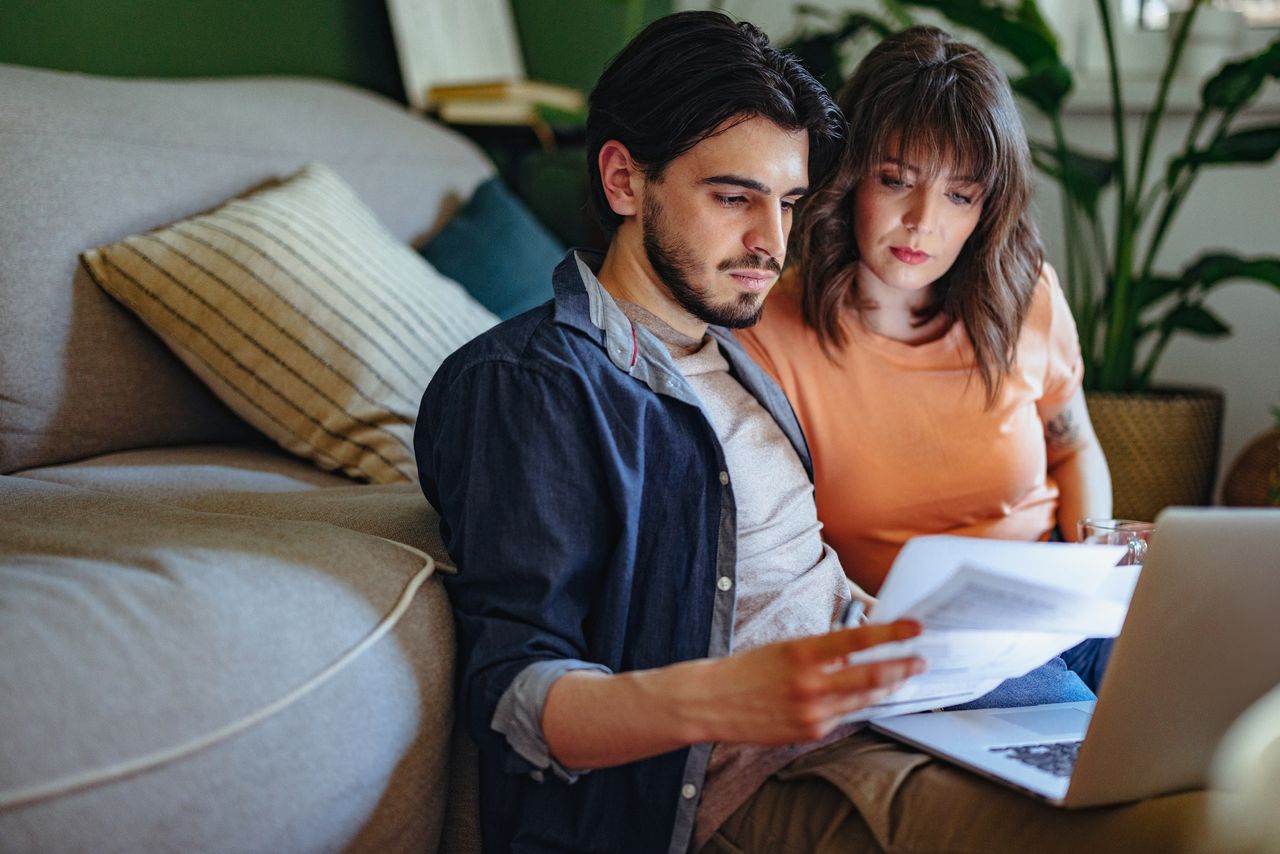 Serious Couple Paying Bills at Home