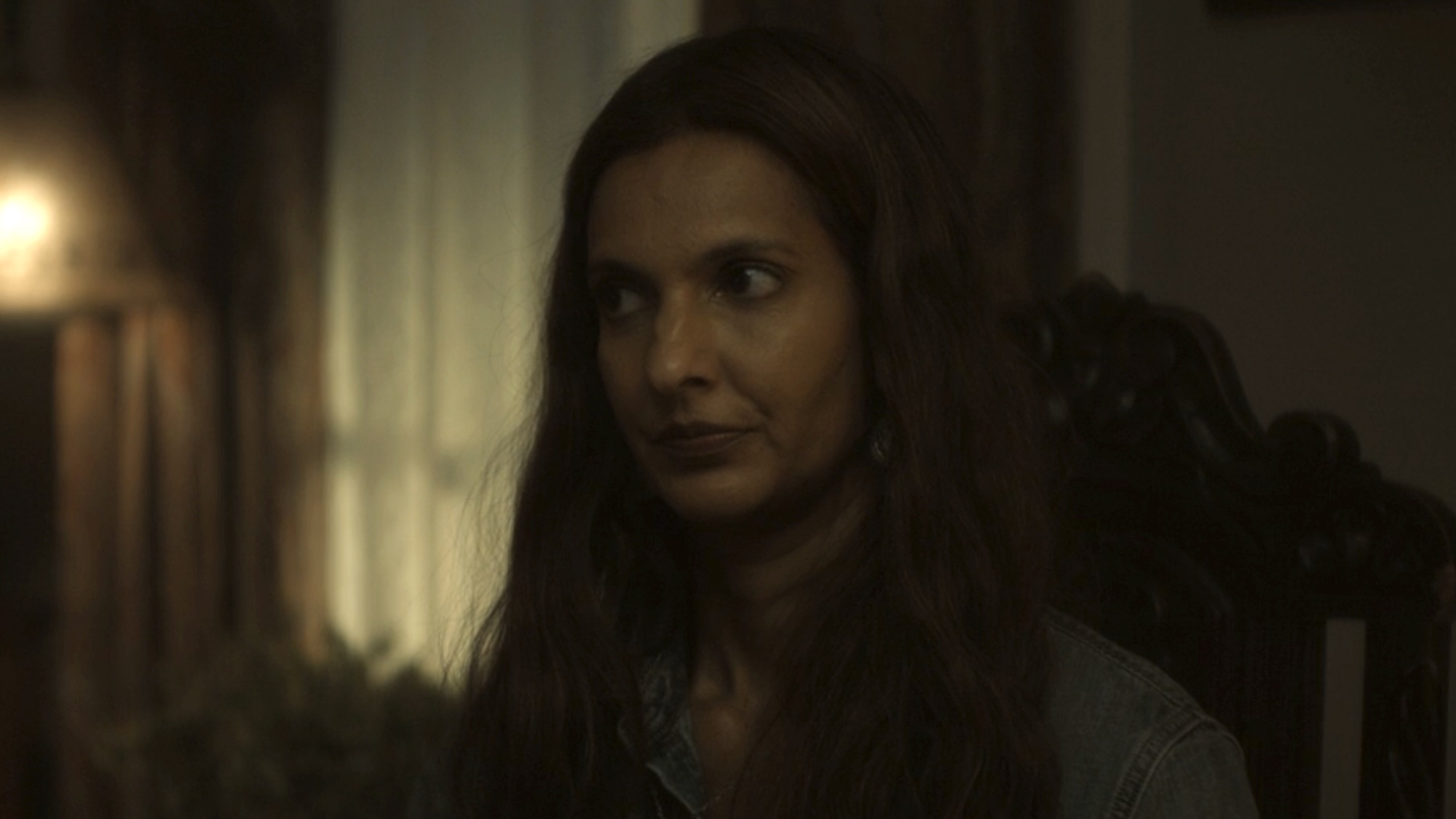 Zoe sitting in Will Macon Sr.'s office in Lanterns Season 1