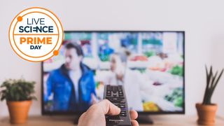 Remote control pointed at a TV screen with Live Science Prime Day logo