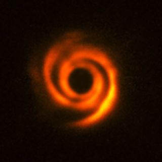 The planet-forming disk around the star HD 135344B, which is about 450 light-years away, has a spiral structure that was most likely created by protoplanets on their way to becoming Jupiter-like bodies. The central star is obscured in this image from the SPHERE instrument on ESO's Very Large Telescope in Chile.